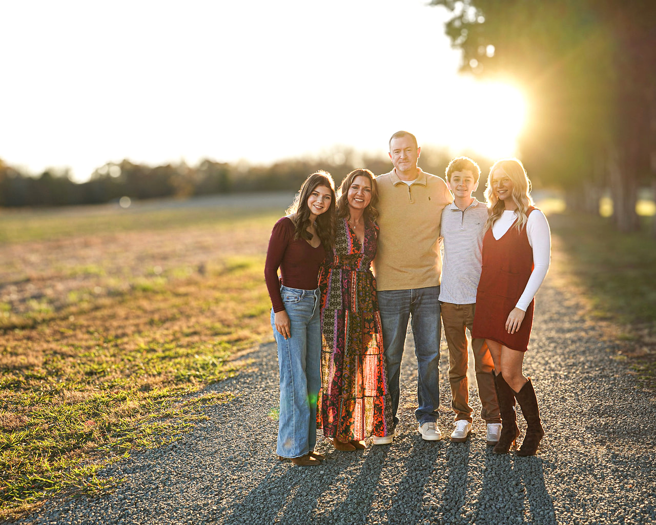 Kevin Stuart with his wife and three children on a country road at sunset